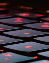 An image of a red glowing keyboard, typically seen on gaming laptops.
